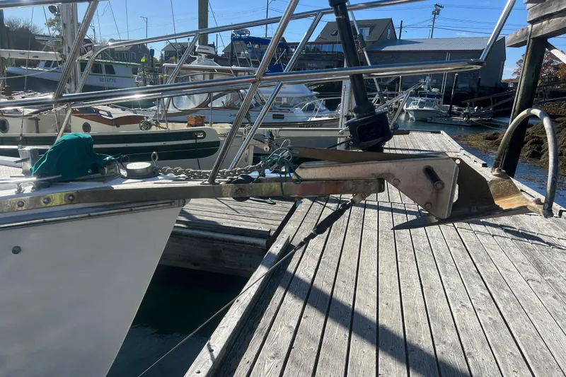 Slide: The Image of 1993 Compac Sloop docked with anchor and chain on wooden pier. - 5
