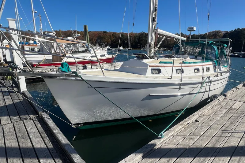 Slide: The Image of 1993 Compac Sloop docked at a marina on a sunny day. - 6