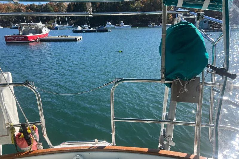 Slide: The Image of 1993 Compac Sloop sailboat view from deck, overlooking marina with boats and clear water. - 9