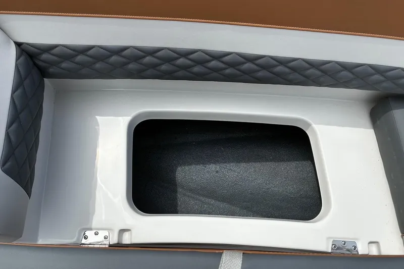 Slide: The Image of 2026 Starcraft SVX 211 OB boat interior storage compartment with quilted upholstery. - 18