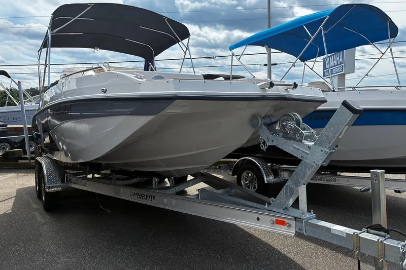 Slide: The Image of 2026 Starcraft SVX 211 OB boat on trailer, featuring a sleek design and canopy. - 2