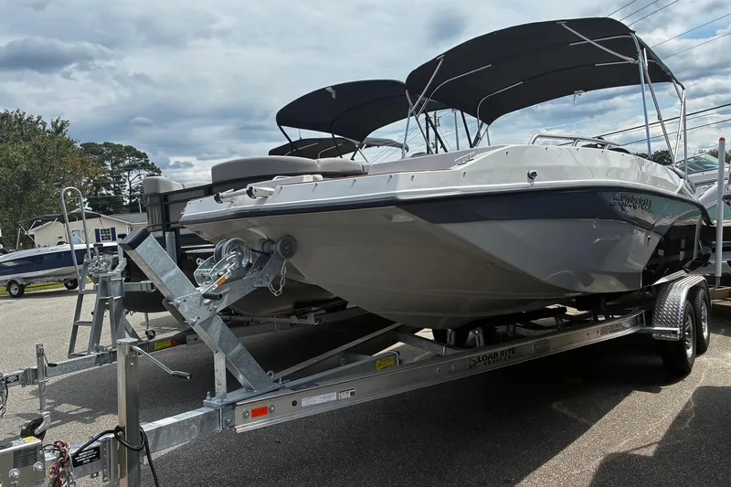 Slide: The Image of 2026 Starcraft SVX 211 OB boat on trailer, parked outdoors under cloudy sky. - 3