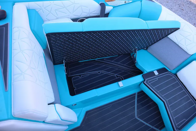 Slide: The Image of 2021 Nautique Super Air Nautique G23 Paragon interior with open storage compartment. - 11