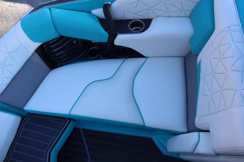 Slide: The Image of 2021 Nautique Super Air Nautique G23 Paragon interior with teal and white seating. - 12