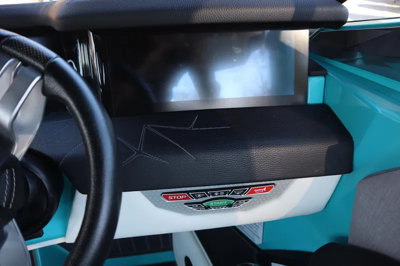 Slide: The Image of 2021 Nautique Super Air Nautique G23 Paragon dashboard with touchscreen and control buttons. - 17