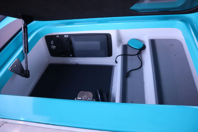 Slide: The Image of 2021 Nautique Super Air Nautique G23 Paragon storage compartment, featuring vibrant blue interior. - 21