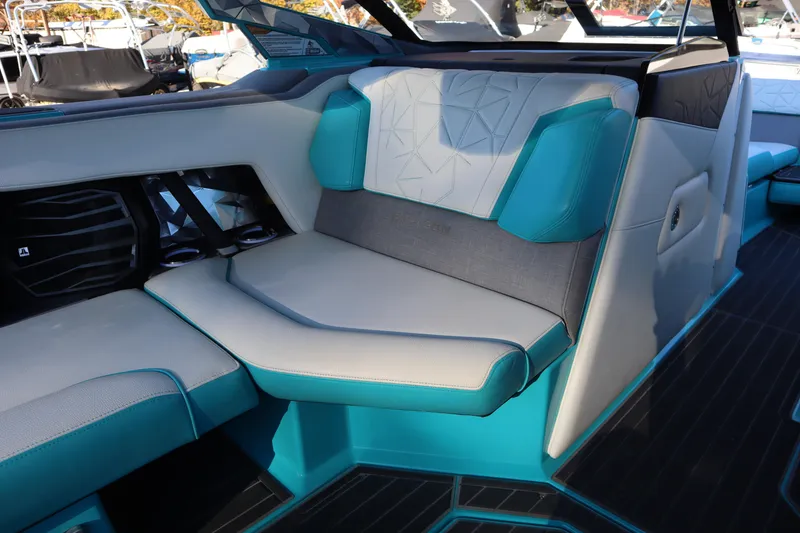 Slide: The Image of 2021 Nautique Super Air Nautique G23 Paragon interior with teal and gray seating. - 22