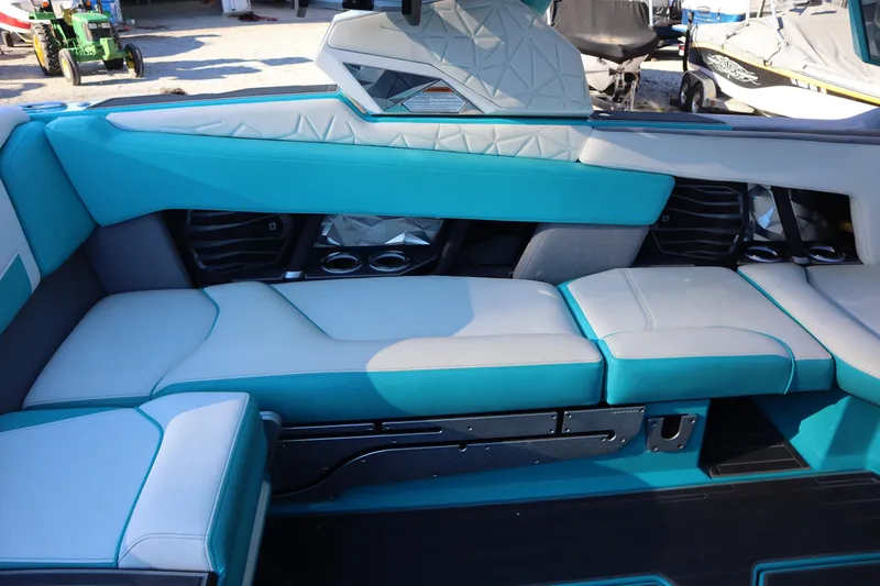 Slide: The Image of 2021 Nautique Super Air Nautique G23 Paragon interior with teal and gray seating. - 24