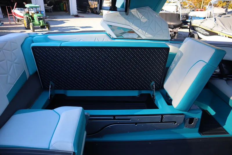 Slide: The Image of 2021 Nautique Super Air Nautique G23 Paragon interior with open storage compartment. - 25