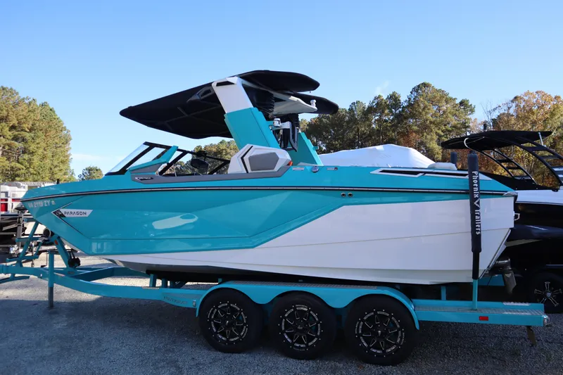 Slide: The Image of 2021 Nautique Super Air Nautique G23 Paragon boat on trailer, turquoise and white design. - 3