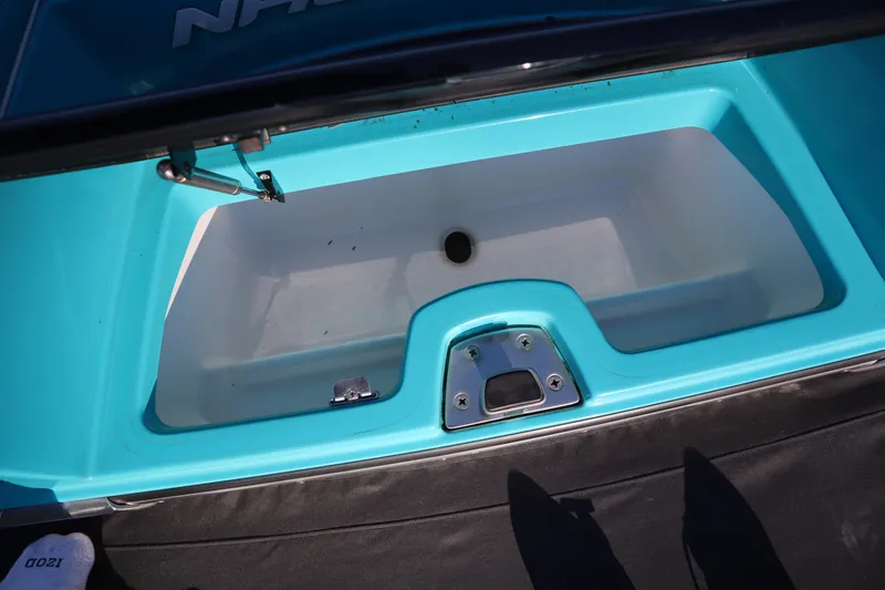 Slide: The Image of 2021 Nautique Super Air Nautique G23 Paragon storage compartment, turquoise interior, open lid. - 35