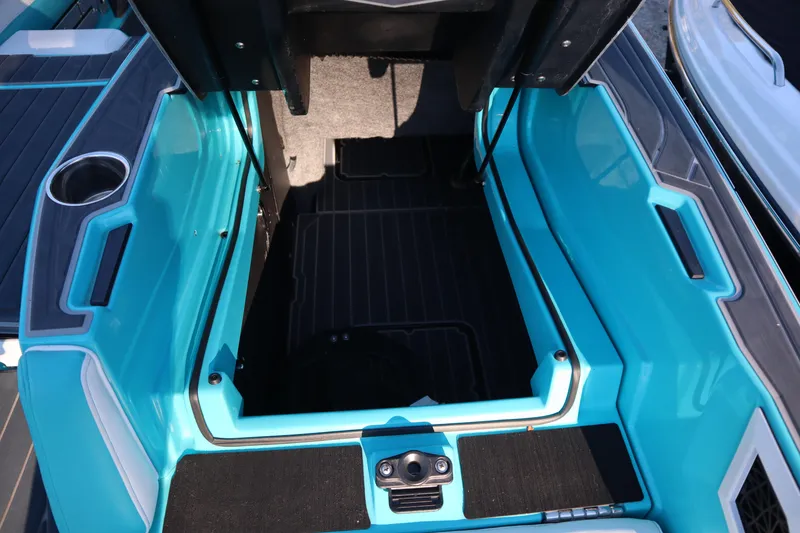 Slide: The Image of 2021 Nautique Super Air Nautique G23 Paragon interior storage compartment, turquoise and black design. - 40