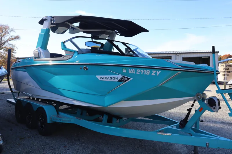 Slide: The Image of 2021 Nautique Super Air Nautique G23 Paragon boat in vibrant blue on trailer. - 6