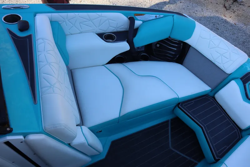 Slide: The Image of 2021 Nautique Super Air Nautique G23 Paragon interior with turquoise and white seating. - 9