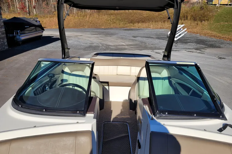 Slide: The Image of 2013 Sea Ray 210 SLX boat interior with dual windshields and seating. - 13