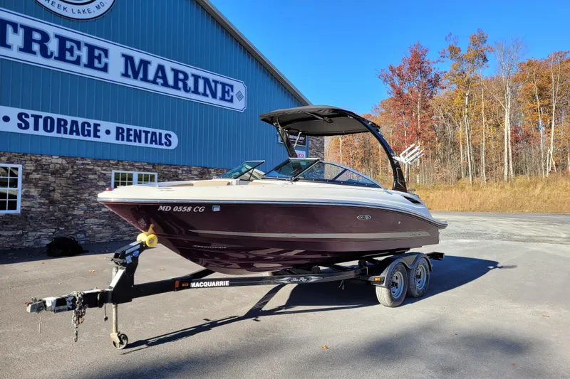 Slide: The Image of 2013 Sea Ray 210 SLX boat on trailer at Tree Marine, autumn backdrop. - 4