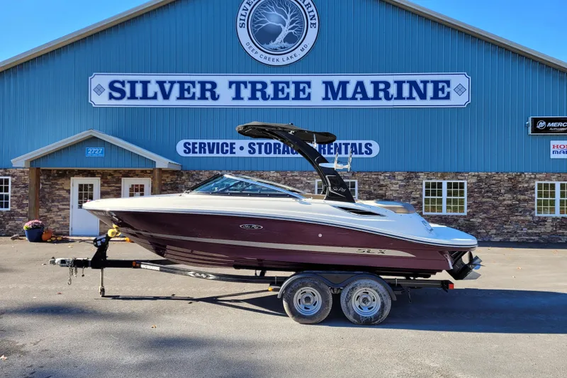 Slide: The Image of 2013 Sea Ray 210 SLX boat on trailer at Silver Tree Marine facility. - 6