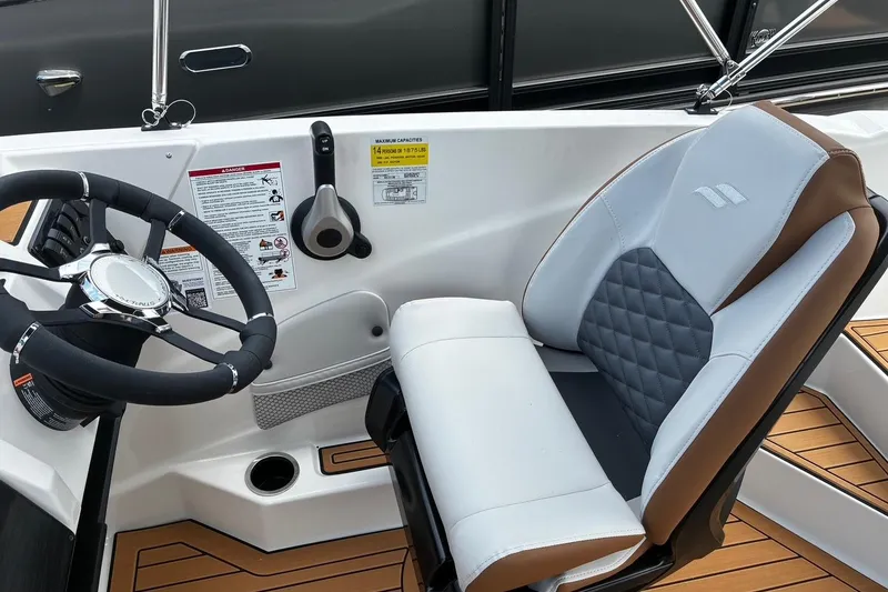Slide: The Image of Interior of 2026 Starcraft SVX 211 OB boat with steering wheel and cushioned seat. - 14
