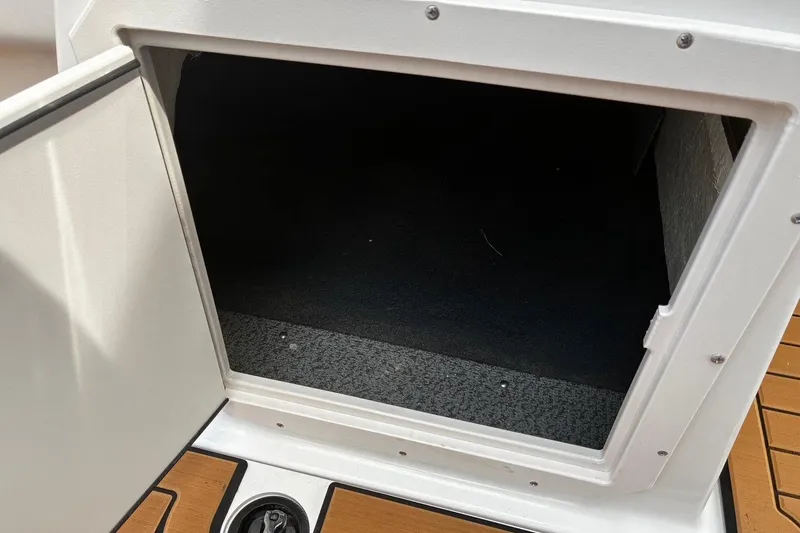 Slide: The Image of Open storage compartment on 2026 Starcraft SVX 211 OB boat, featuring a clean interior. - 16
