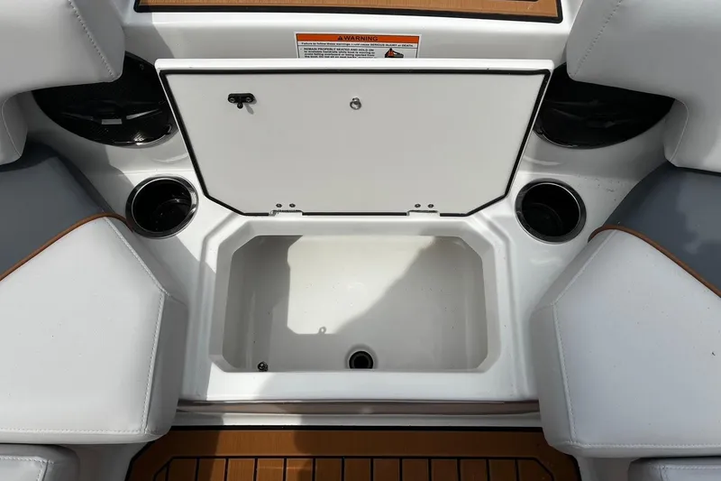 Slide: The Image of 2026 Starcraft SVX 211 OB boat interior with storage compartment and cup holders. - 20