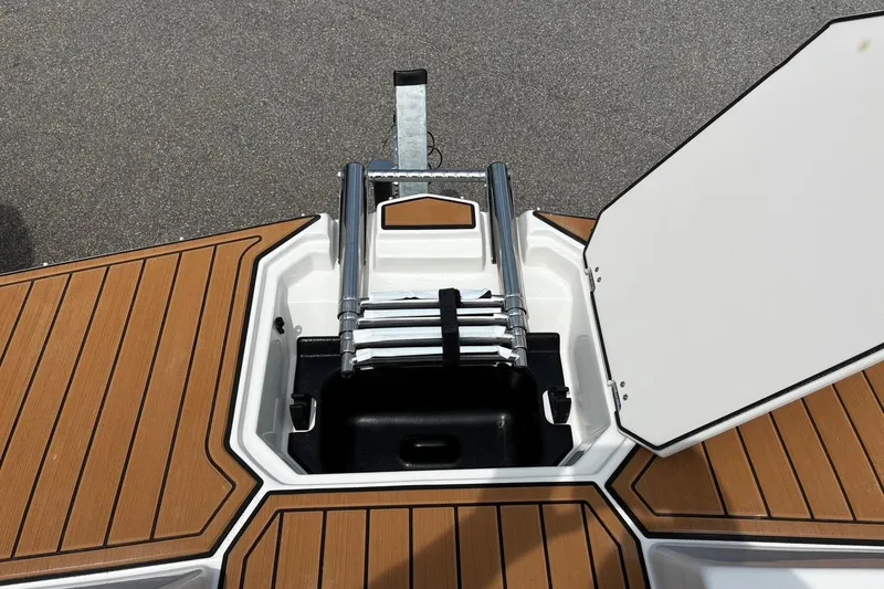 Slide: The Image of 2026 Starcraft SVX 211 OB boat with open hatch and retractable ladder on deck. - 22