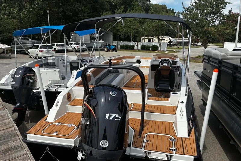 Slide: The Image of 2026 Starcraft SVX 211 OB boat with Yamaha outboard motor, docked in a marina. - 4