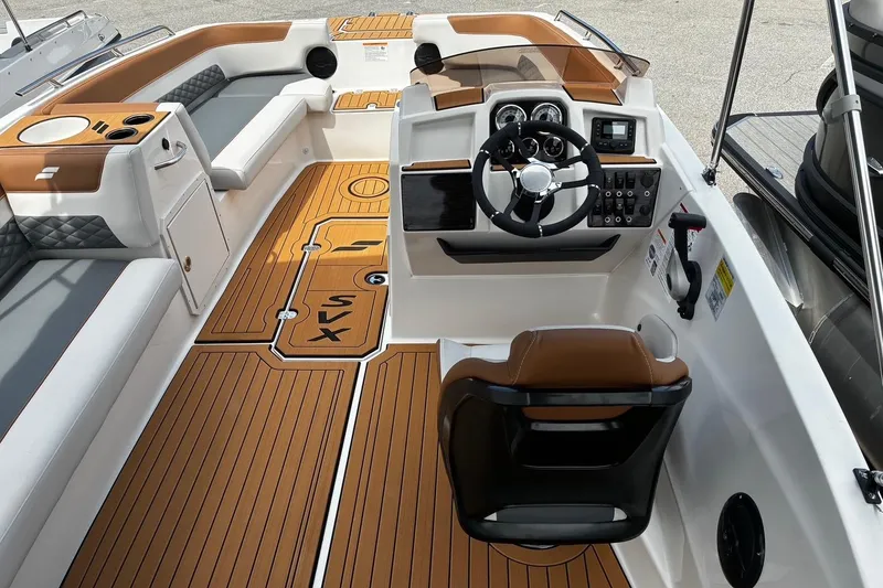 Slide: The Image of 2026 Starcraft SVX 211 OB boat interior with modern helm and stylish seating. - 7