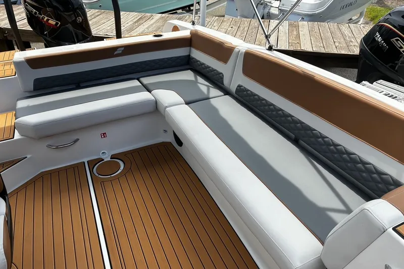 Slide: The Image of 2026 Starcraft SVX 211 OB boat interior with cushioned seating and teak-style flooring. - 8