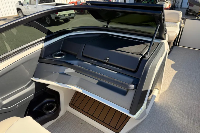Slide: The Image of 2026 Tahoe Pontoon Cascade Quad Lounger Windshield interior with seating and storage compartments. - 3