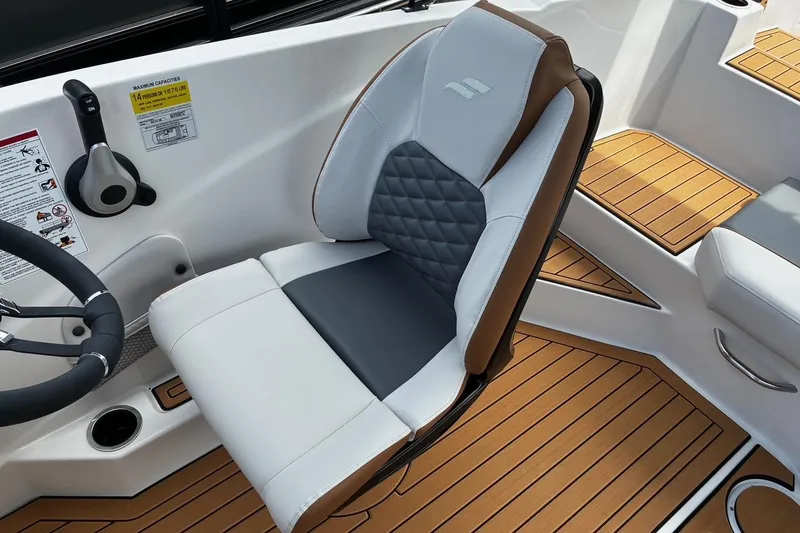 Slide: The Image of Captain's seat in 2026 Starcraft SVX 211 OB boat, featuring sleek design and wood-textured flooring. - 15