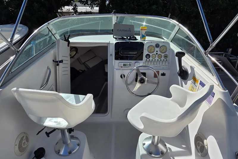 Slide: The Image of 2001 Pro-Line 22 Walk boat cockpit with steering wheel and dual seats. - 10