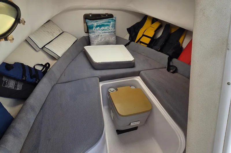 Slide: The Image of Cozy cabin interior of 2001 Pro-Line 22 Walk boat with cushions and life jackets. - 12