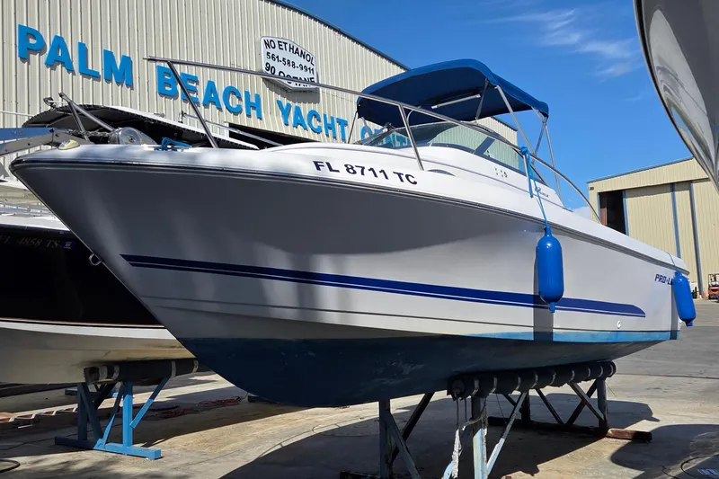 Slide: The Image of 2001 Pro-Line 22 Walk boat at Palm Beach Yacht Center, displayed on a stand. - 2