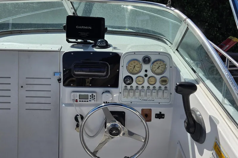 Slide: The Image of 2001 Pro-Line 22 Walk boat dashboard with Garmin GPS and steering wheel. - 8