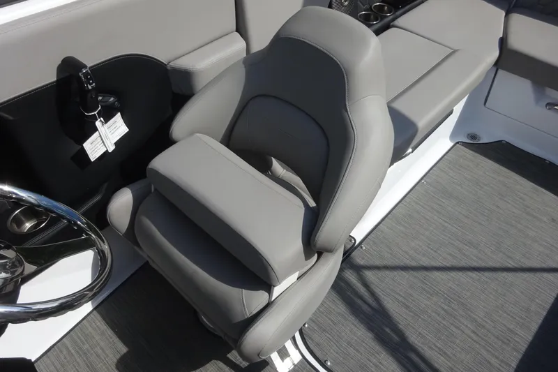 Slide: The Image of 2022 Four Winns H4 OB boat interior with gray captain's seat and steering wheel. - 10