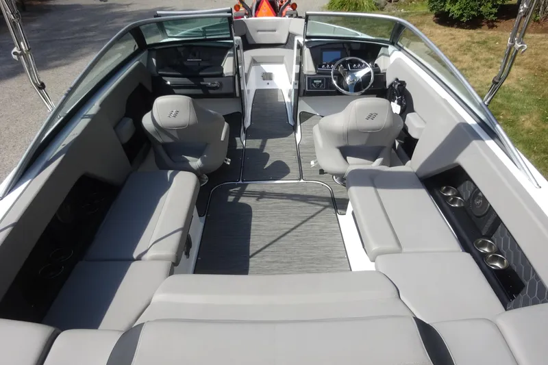 Slide: The Image of 2022 Four Winns H4 OB boat interior with gray seating and modern dashboard. - 7