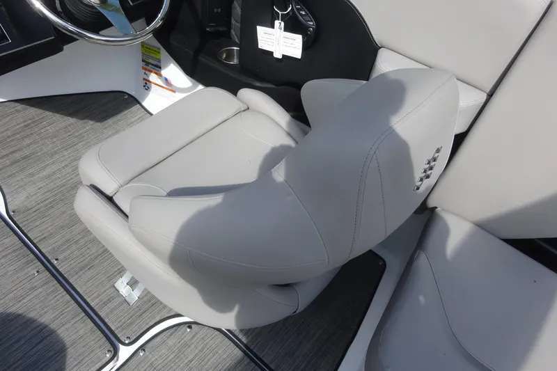 Slide: The Image of 2022 Four Winns H4 OB boat interior with gray seating and steering wheel. - 8