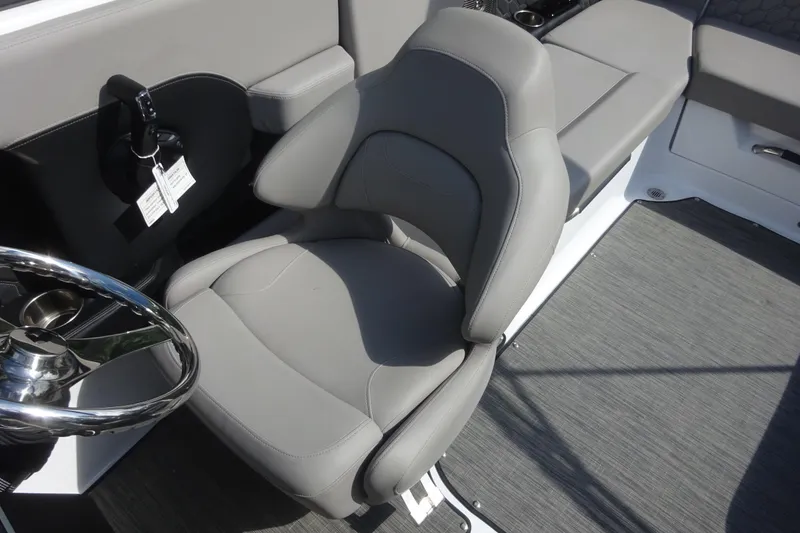 Slide: The Image of 2022 Four Winns H4 OB boat interior with gray captain's seat and steering wheel. - 9