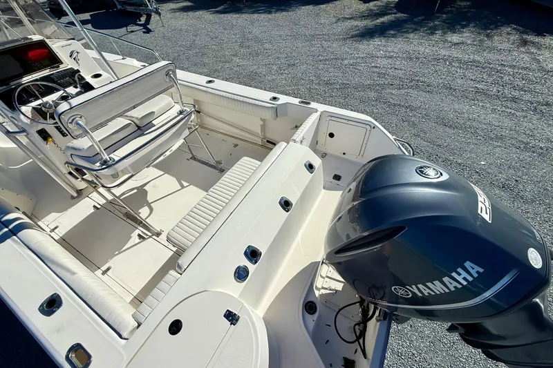 Slide: The Image of 2001 Boston Whaler 230 Outrage boat interior with Yamaha engine, featuring seating and control console. - 12