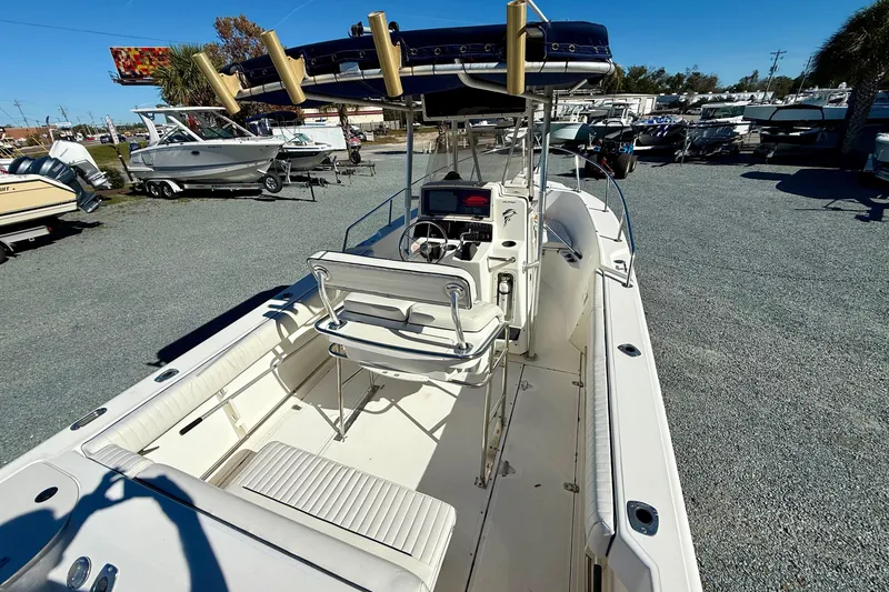 Slide: The Image of 2001 Boston Whaler 230 Outrage boat with center console and seating, displayed outdoors. - 14