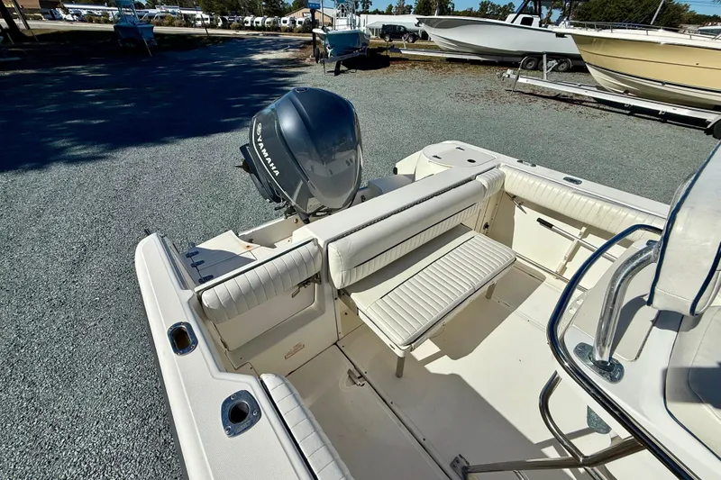 Slide: The Image of 2001 Boston Whaler 230 Outrage boat interior with Yamaha engine, featuring seating and storage. - 15