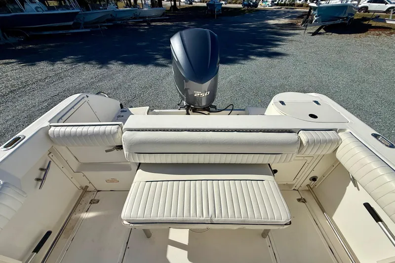 Slide: The Image of 2001 Boston Whaler 230 Outrage boat interior with seating and outboard motor. - 16
