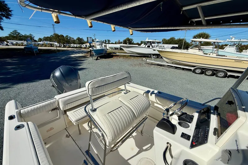Slide: The Image of 2001 Boston Whaler 230 Outrage boat interior with seating and control panel. - 19
