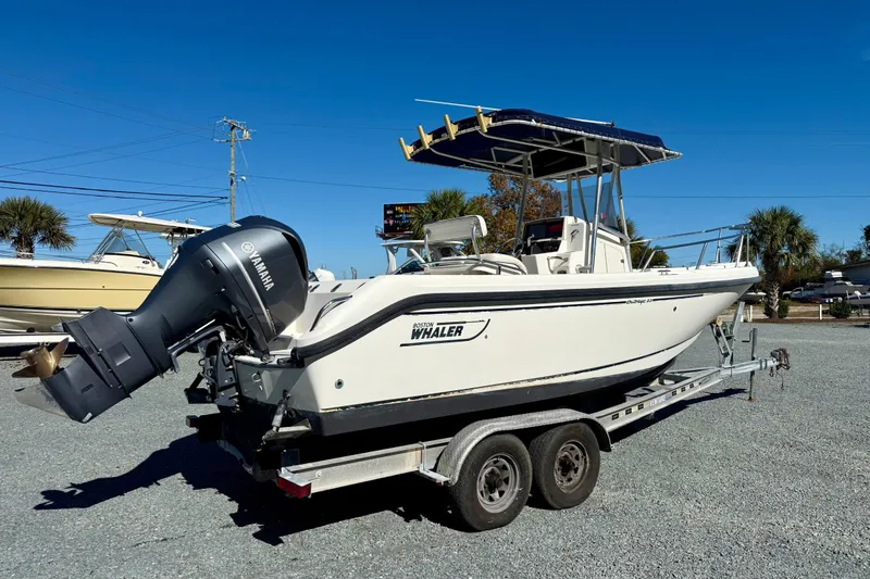 Slide: The Image of 2001 Boston Whaler 230 Outrage boat on trailer with Yamaha outboard motor. - 2