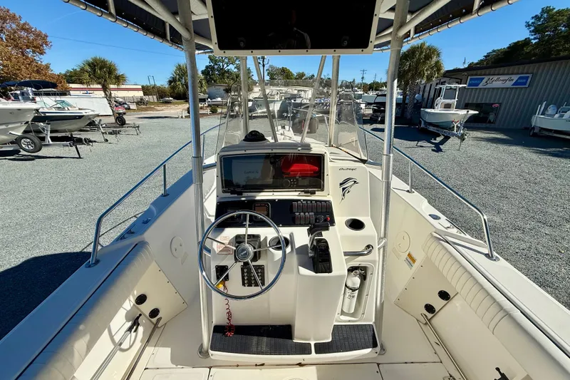 Slide: The Image of 2001 Boston Whaler 230 Outrage boat interior with steering wheel and control panel. - 20