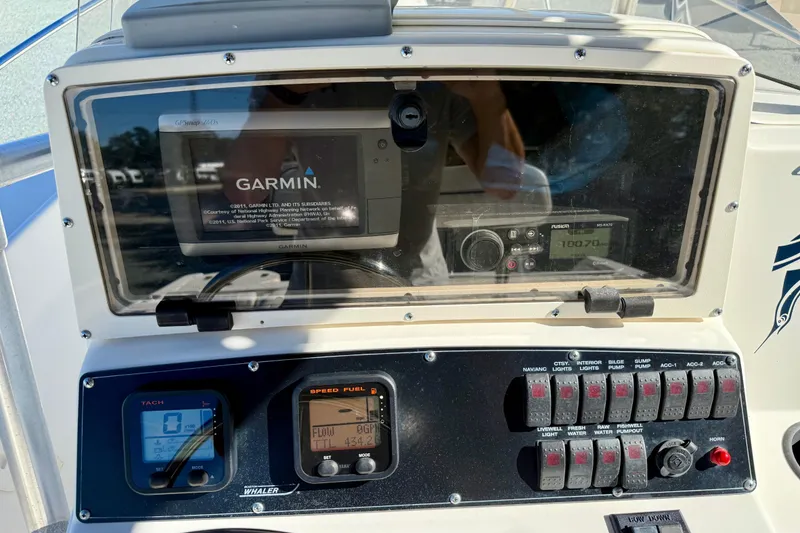Slide: The Image of Boston Whaler 230 Outrage 2001 dashboard with Garmin GPS and control panel. - 22