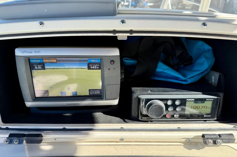 Slide: The Image of Boston Whaler 230 Outrage 2001 dashboard with Garmin GPS and Fusion radio system. - 23