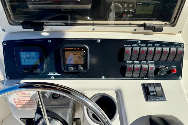 Slide: The Image of Control panel of a 2001 Boston Whaler 230 Outrage boat with gauges and switches. - 24