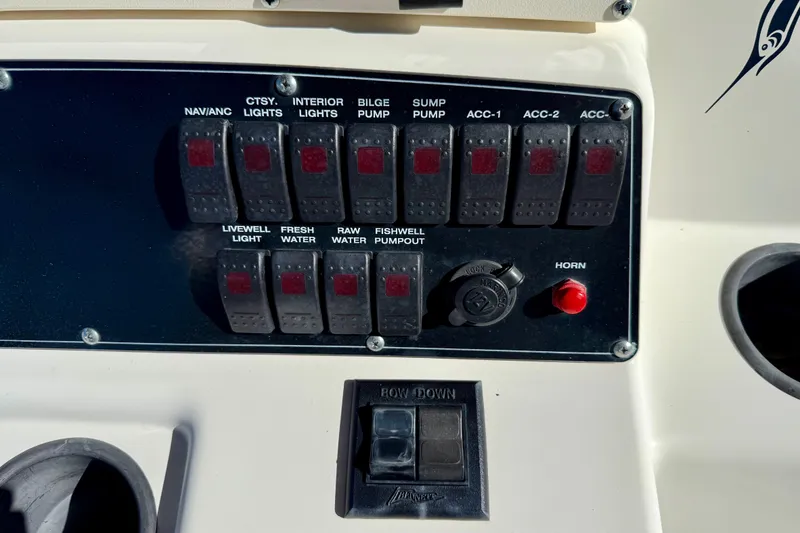 Slide: The Image of Control panel of a 2001 Boston Whaler 230 Outrage boat with labeled switches. - 25