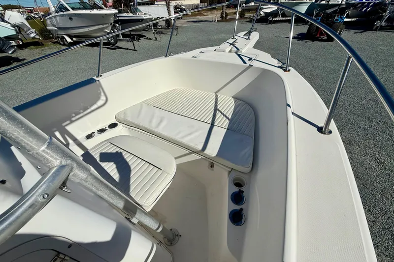 Slide: The Image of 2001 Boston Whaler 230 Outrage boat interior with seating and railings. - 28